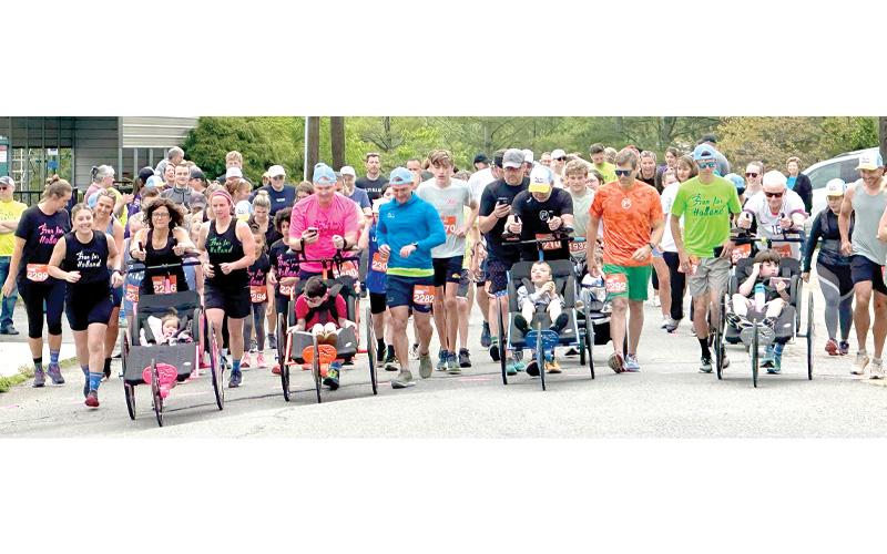 Photo courtesy of Kenny and Heather Burleson.  Run for Holland brought these runners together in 2025, and some people who could not attend in person signed up as spirit runners, paying the registration fee and running at their homes. The 5K race will start at 8:30 am on Saturday, May 2, at Riverside Park, Spruce Pine.