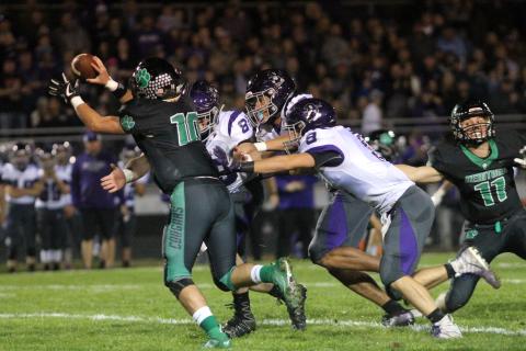 Mitchell High School juniors Cole Sparks (No. 89), Caius Peterson (No. 2) and Ty Sparks (No. 9) converge on Mountain Heritage quarterback Callin Randolph Friday, Oct. 18 during the Mountaineers' 14-6 loss to the Cougars in Burnsville. (MNJ photo/Cory Spiers)