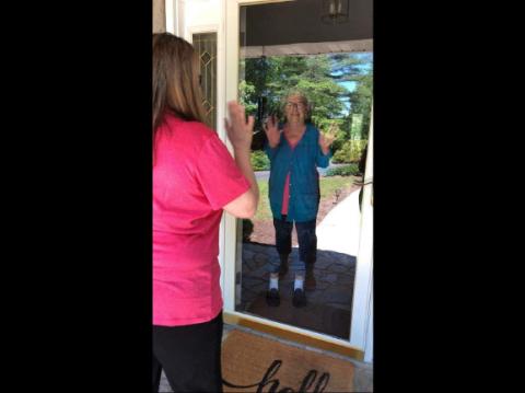 Lillian Benton, a patient involved with the Community Health Program in Mitchell County, waves to her community health worker. Photo courtesy of MCHP.