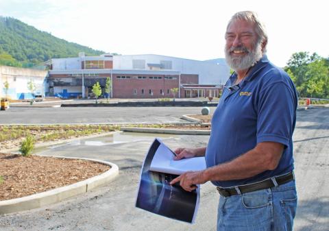 President of Mayland Community College John Boyd shows off architecture plans for the soon-to-be Three Peaks Enrichment Center. The old Pine Bridge complex and hotel are both under construction to become part of Mayland’s campus. 