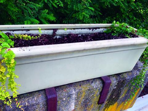 A decorative planter in Bakersville sits without flowers after being vandalized. (Submitted photo)