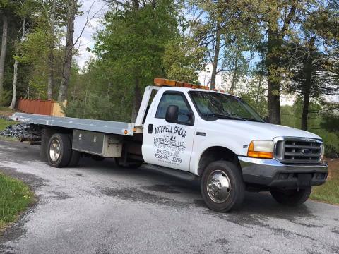 Two men were arrested this past week accused of stealing a rollback truck belonging to Mitchell County Commissioner Matthew “Vern” Grindstaff.