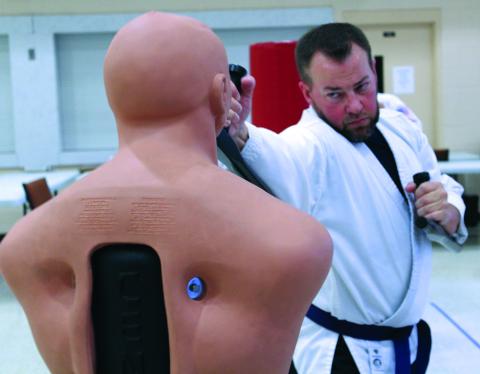 Local martial artist Brett Cloer practices delivering blows on a dummy during a recent martial arts class at Spruce Pine First Baptist Church. Cloer is one of dozens of students of all ages and experience levels who attend the classes twice per week to hone their skills. Classes are taught by Rocky Branch. (MNJ photo/Cory Spiers)