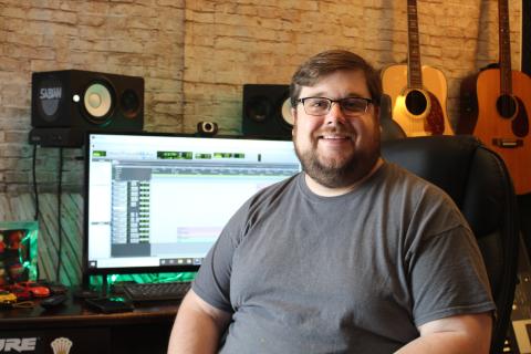 Josh McKinney sits in his new recording studio, Josh McKinney Studios. The studio opened last month and McKinney has already had a local gospel group, Contenders for Faith, record their most recent album in the space. The studio has allowed McKinney to turn his musical passion into a business. (MNJ photo/Juliana Walker)