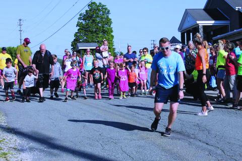 Run for Holland Organizer Adam Burleson takes off and leads the children’s portion of the annual Run for Holland charity race in this file photo from 2019. The annual event was originally delayed until Sept. 19 and has now moved into a virtual format due to the ongoing pandemic. Runners will complete their treks on their own time and submit their times online. The event will still benefit the local special needs community and participants can still win prizes. (MNJ file photo)