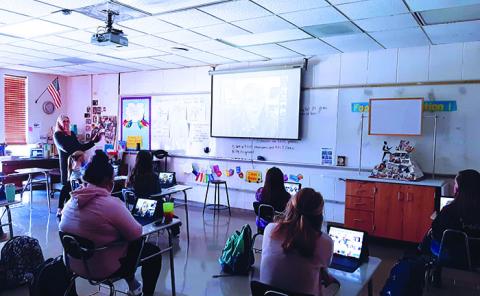 Early childhood education students at Mitchell High School lsiten intently as Ruthie Styles, Community Development Manager for the Blue Ridge Partnership for Children, addresses the class virtually. The students usually go on an annual field trip to the BRPFC, which is located in Burnsville. With the trip canceled this year due to the ongoing pandemic, the BRPFC brought the field trip to them by communicating completely virtually. (Submitted photo)