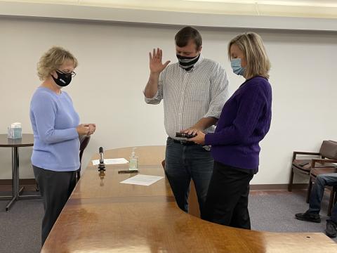 Newly-elected Mitchell County Commissioner Brandon Pittman is sworn in by Mitchell County Register of Deeds Kathy Laws as his wife Lisa Pittman helps him by holding the Bible on Monday, Dec. 7. The new board met later that day and approved changes, including holding two monthly meetings. (MNJ photo/Juliana Walker)