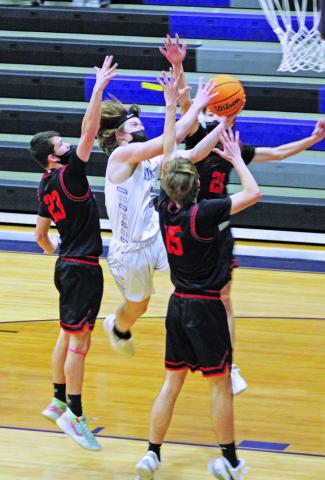 Mitchell’s Ty Turbyfill plows through a trio of Avery defenders on Friday, Jan. 29 as he drives the lane and attempts to finish at the rim. The Mountaineers defeated Avery and have now won four straight after starting the season 0-4. (MNJ photo/Cory Spiers)
