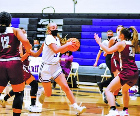 Senior guard Jill Pittman navigates the floor amid a trio of Owen defenders and looks for a friend to pass to during a home game on Wednesday, Feb. 3. Pittman and the Mountaineers blew out Owen and beat Mountain Heritage the next day to stay perfect. (Photo by Tessa Taylor)