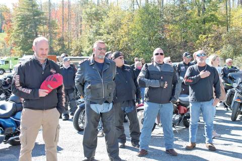 MNJ photo/Rachel Hoskins - Riders take a moment to salute the flag during the singing of the National Anthem.