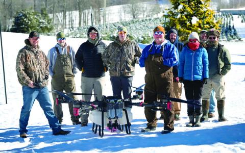MNJ photo/Sarah Quintas.  Local farmers gather around a state-of-the-art agricultural drone.