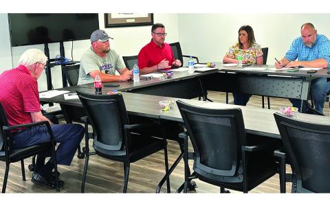 Photo/Mitchell County Government. Mitchell County officials, Lloyd Hise, Brock Duncan, Stan Cook, Christy Young and Allen Cook review bids for construction of the new recreation center.