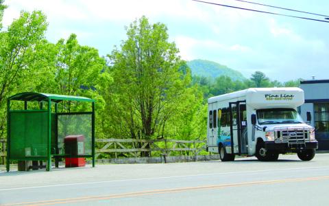 MNJ photo/Sarah Atkins. Pine Line picks up passengers at a stop in downtown Spruce Pine.