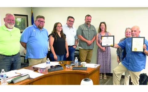 MNJ photo/Mariel Williams. The Mitchell County Board of Commissioners recently honored Mike Gunter, a volunteer for Mitchell County Shepherd’s Staff, for receiving the Governor’s Volunteer Award. From left are Commissioner Jeff Harding, Commissioner Clayton Roberts, Chair Harley Masters, Vice-Chair Steve Pitman, Commissioner Brandon Dean Pittman, Rebecca Hall of High Country United Way, Gunter’s wife Catherine Gunter, and Mike Gunter. 