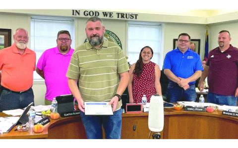 MNJ photo/Mariel Williams. The Mitchell County Board of Commissioners honored Josh Nelson as Employee of the Month at a recent board meeting. From left are commissioners Jeff Harding and Clayton Roberts, Nelson, Board Chair Harley Masters, and commissioners Steve Pitman and Brandon Pittman. 