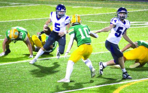 MNJ photos/Brian Hobson. Quarterback Caleb Cook eludes two defenders and takes off down field.