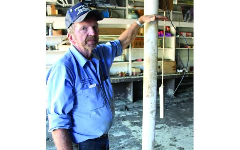 MNJ photo/Mariel Williams.  Nick Whitson shows the water mark where Hurricane Helene floodwaters stopped rising in O.C. Whitson & Sons, a furniture and general store that has stood in Green Mountain for almost 100 years.