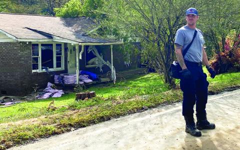 MNJ photo/ Rachel Hoskins.  A member of the Virginia Task Force Urban Search and Rescue team goes door to door checking on residents in flooded areas. 