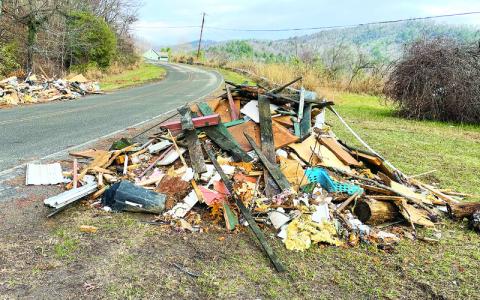 MNJ Photo/Mariel Williams. Debris pickup is continuing along Mitchell County roadsides. According to debris contractors, the process has been complicated by increased dump truck traffic and the fact that old piles are replaced by new as property owners continue to haul rubbish out of flooded areas.