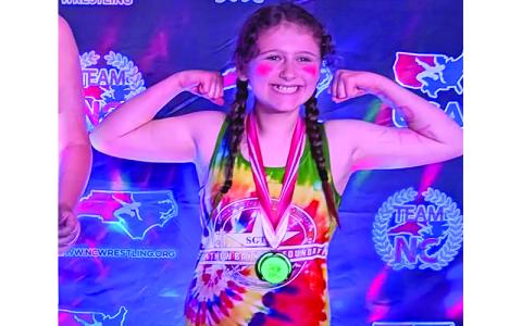 Submitted photo. Rebecca Smith flexes a smile for her silver medal performance.