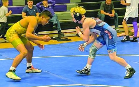 Submitted photos.  Bryson McFalls, first place in Junior Boys 132-138, wrestles against an Alleghany opponent.