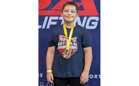 MNJ Photo/Brian Hobson.  Connor Hobson poses with his medal after the championship. Hobson set a new National record with a 43kg bench press.
