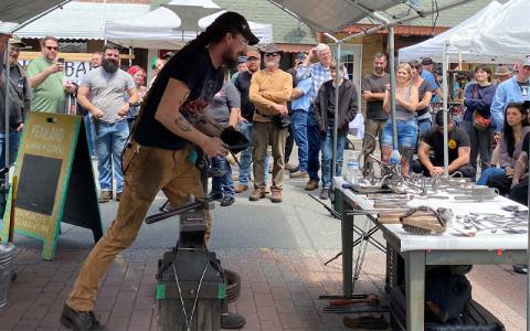 MNJ file photo/Rachel Hoskins.  Pete Braspenninx, owner of Phyre Forge in Michigan, drew a big crowed as the featured blacksmith for the 2024 Fire on the Mountain in downtown Spruce Pine. This year’s featured blacksmith is Anton Yakushev.