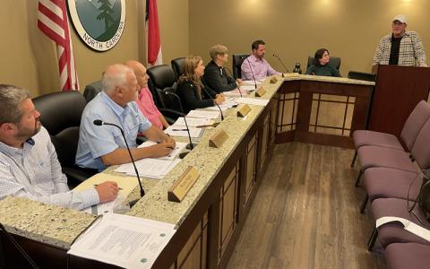MNJ Photo/Mariel Williams.  David Niven, right, of DT’s Blue Ridge Java speaks to the Spruce Pine Town Council about downtown flood cleanup past and present.