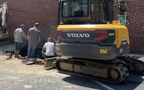 MNJ Photo/Mariel Williams.  Spruce Pine Public Works employees work on repairing a sewer leak on Crystal Street.