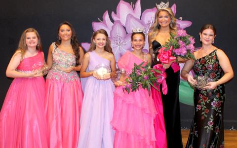 Submitted photo.  The new 2026 NC Rhododendron Queen Kaylyn Fairchild and Junior Queen Kimber Ostrander were crowned Saturday. From left are Scout Stevenson (congeniality), GraceLynn Lovick (second runner up), Eliza Bray (first runner up, evening gown, talent) Kimber (junior queen and interview), Kaylyn (queen, and also winning interview and swimsuit), and Gracyn Strickland (first runner up, talent and congenitally winner).