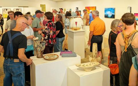 MNJ Photos/Steffen Silvis.  Top: Kurt Anderson at work in his Spruce Pine studio on the Toe River Arts Studio Tour. Bottom: Art enthusiasts gather for an opening night reception at Kokol Gallery downtown Spruce Pine. The reception kicked off Toe River Arts Studio Tour this past weekend.