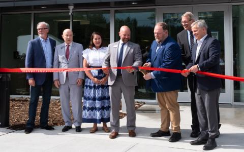 MNJ Photos/Sarah Atkins.  Sen. Ralph Hise cuts the ribbon during the grand opening of the new YMCA facility. From left are Van Phillips, John Blackburn, Sarah Grimes, Williams YMCA CEO Trey Oakley, Hise, Mayland Community College President John Boyd and N.C. Gov. Josh Stein.
