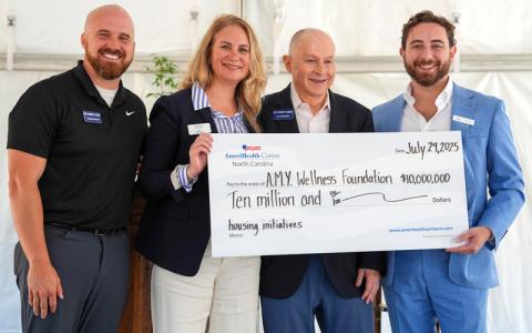 Submitted photo.  Thomas Johnson, Chief Cares, associate director, Heidi Chan, AmeriHealth, market president, John Blackburn, AMY Wellness Foundation, executive director, and Luke Howe, AMY’s executive director hold a check for $10 million.