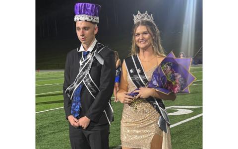 Photo/Laz Aguayo. The Mitchell High School Mountaineers defeated the Polk County Wolverines 39-7 at Homecoming Friday, Sept. 26. Mitchell High School 2025 Homecoming King Aiden Ledford, left, and Queen Piper Cook greet their supporters. Ledford and Cook were officially crowned the reigning king and queen Friday. 