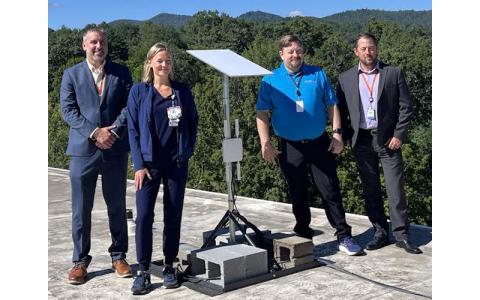 Submitted photo.  Sean Morrison, Carrie James, Joe Seely and AJ Shipman show off the newly-installed BlueNet communications dish on the roof of Blue Ridge Regional Hospital.