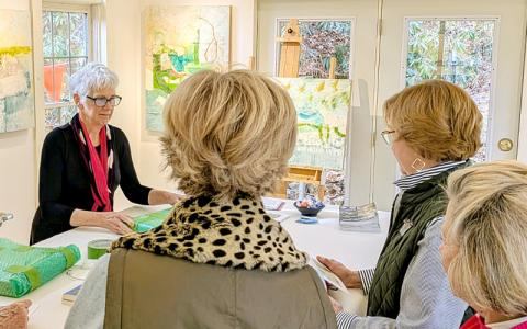 MNJ Photo/Steffen Silvis. Painter Carmen Grier, left, chats with three Charlotte art collectors while wrapping their purchases. The biannual Studio Tours bring in a number of art fans from outside the area. 