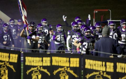MNJ Photo/Blake Thayer.  The Mitchell Mountaineers thunder onto the field for their 51-13 victory over the Langtree Charter Lions.