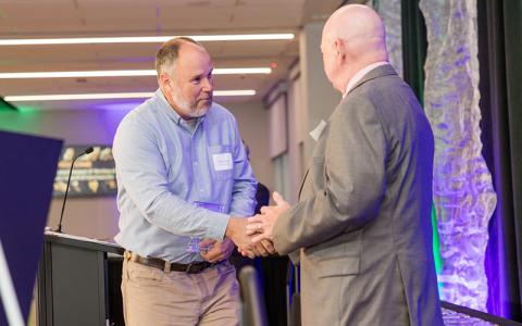 Submitted photo.  Mitchell County Manager Allen Cook, left, accepts the 2025 Outstanding Local Government Manager award from the High Country Council of Governments.