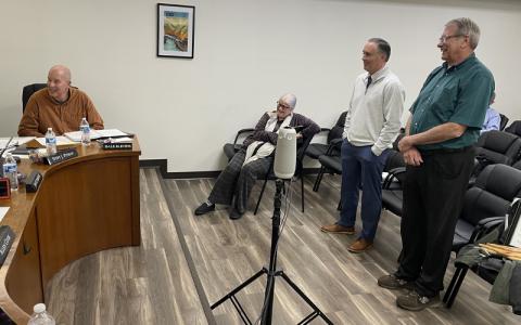 MNJ Photo/Mariel Williams.  Outgoing Mayland Community College President John Boyd, right, introduces his replacement, Aron Gabriel, to the Mitchell County Board of Commissioners.
