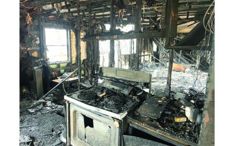 MNJ Photo/Mariel Williams.  A man died when this trailer home was gutted by fire last week. The home is located on Cardinal Lane in Spruce Pine. 
