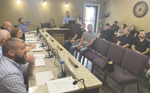 MNJ Photo/Mariel Williams. Jon Blasco and Kayleigh Gill give a presentation to the Spruce Pine Town Council on behalf of engineering firm WithersRavenel. The presentation on revitalizing the downtown streetscape attracted a bigger crowd than usual to the meeting.