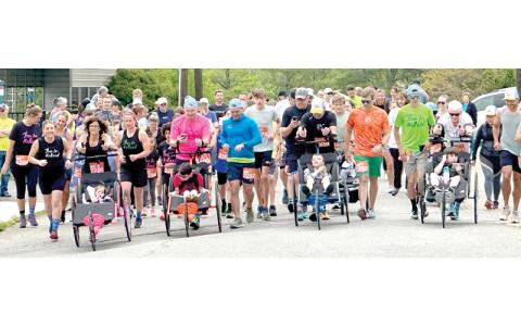 Photo courtesy of Kenny and Heather Burleson.  Run for Holland brought these runners together in 2025, and some people who could not attend in person signed up as spirit runners, paying the registration fee and running at their homes. The 5K race will start at 8:30 am on Saturday, May 2, at Riverside Park, Spruce Pine.