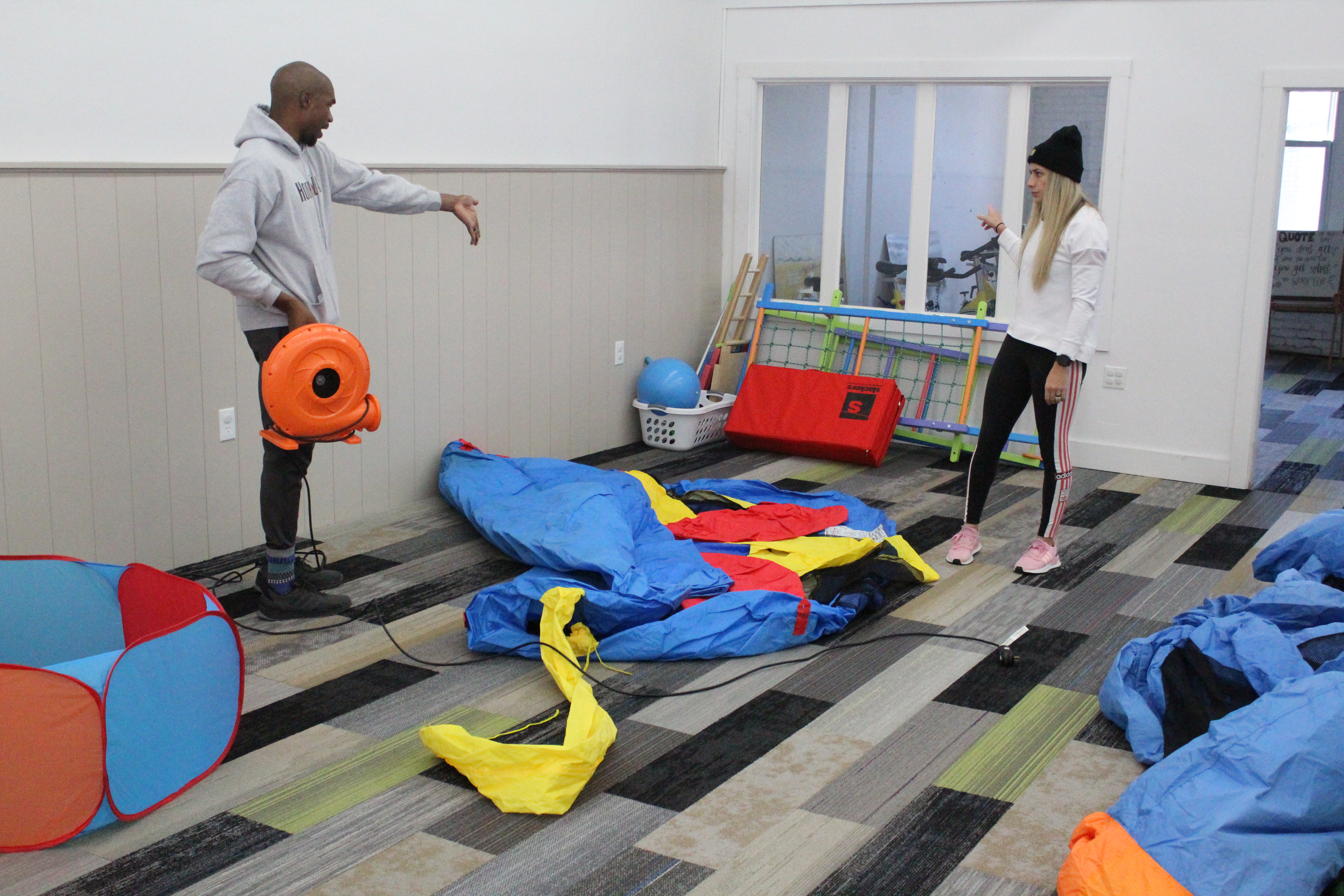 John Williams and his wife, Whitney, arrange inflatable bouncy houses inside their new business, Wren and Wrae’s Clubhouse, at 218 Oak Ave. in Spruce Pine.  The clubhouse offers inflatables, toys and other options for children while Whitney, a personal trainer, will use part of the building to host a variety of exercise classes for adults. Wren and Wrae’s will also be available to host birthday parties and other events. (Brandon Roberts/MNJ)