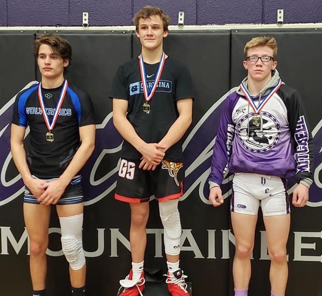 Mitchell senior Dylan Lowery, right, earned a second-place finish in the 120-pound weight class at the Western highlands Conference Tournament. (Submitted) 