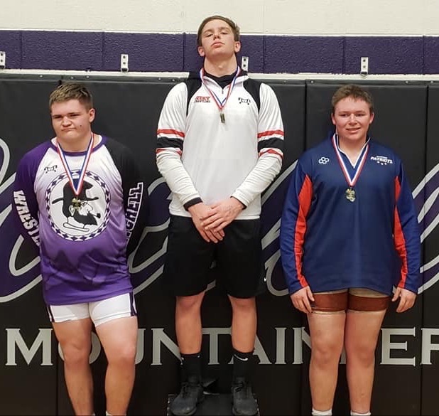 Mitchell senior Samuel Shook, left, won third place in the 220-pound weight class at the Western highlands Conference Tournament. (Submitted)