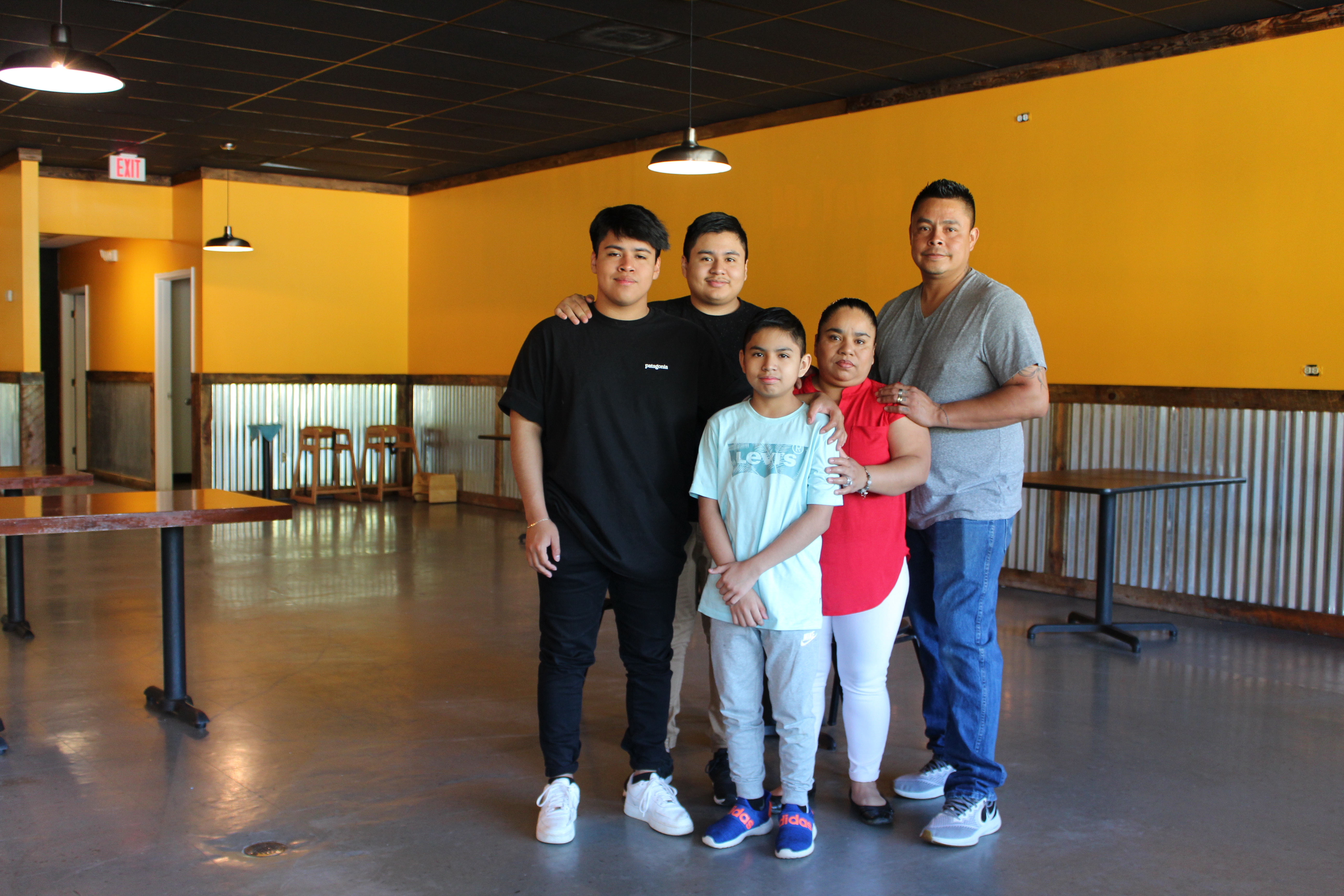 Claudia Pile and her three sons, left to right, Johnny, James and Joshua Pile, and husband Victor Hernandez in their new  restaurant space in the Spruce Pine Commons  Shopping Center. They hope to open the new location in two weeks. Photo by Juliana Walker/MNJ.