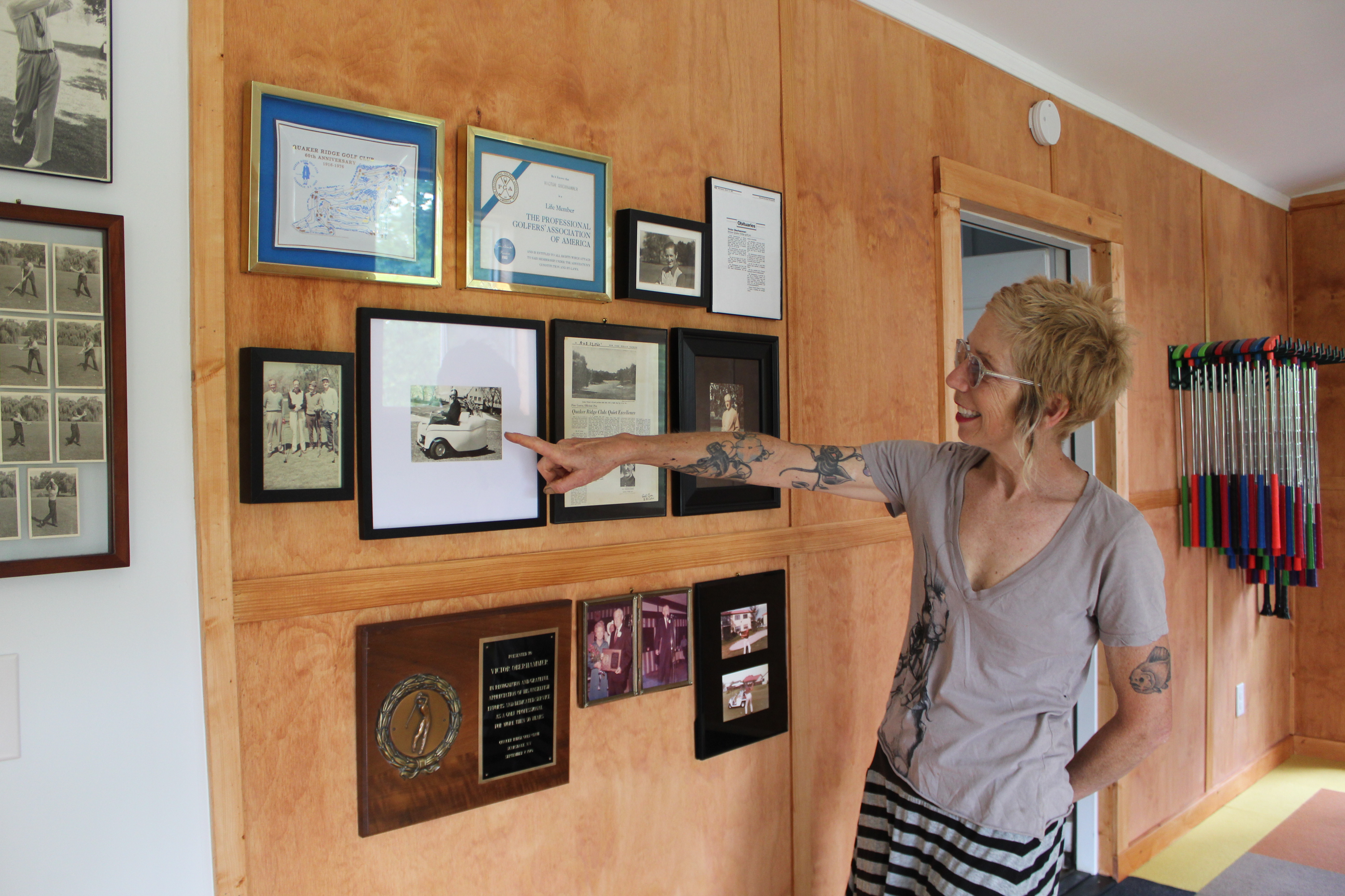 Kim Oberhammer points to photos and memorabilia of her grandfather, Victor.