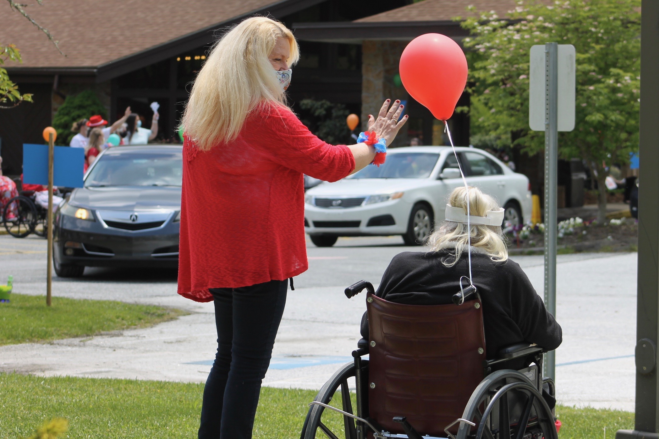 Brian Center Activities Director Debbie Finley, left, and resident Mary Jarvis wave at cars passing by Thursday, May 14, during a drive-thru parade. (Photos by Juliana Walker/MNJ)