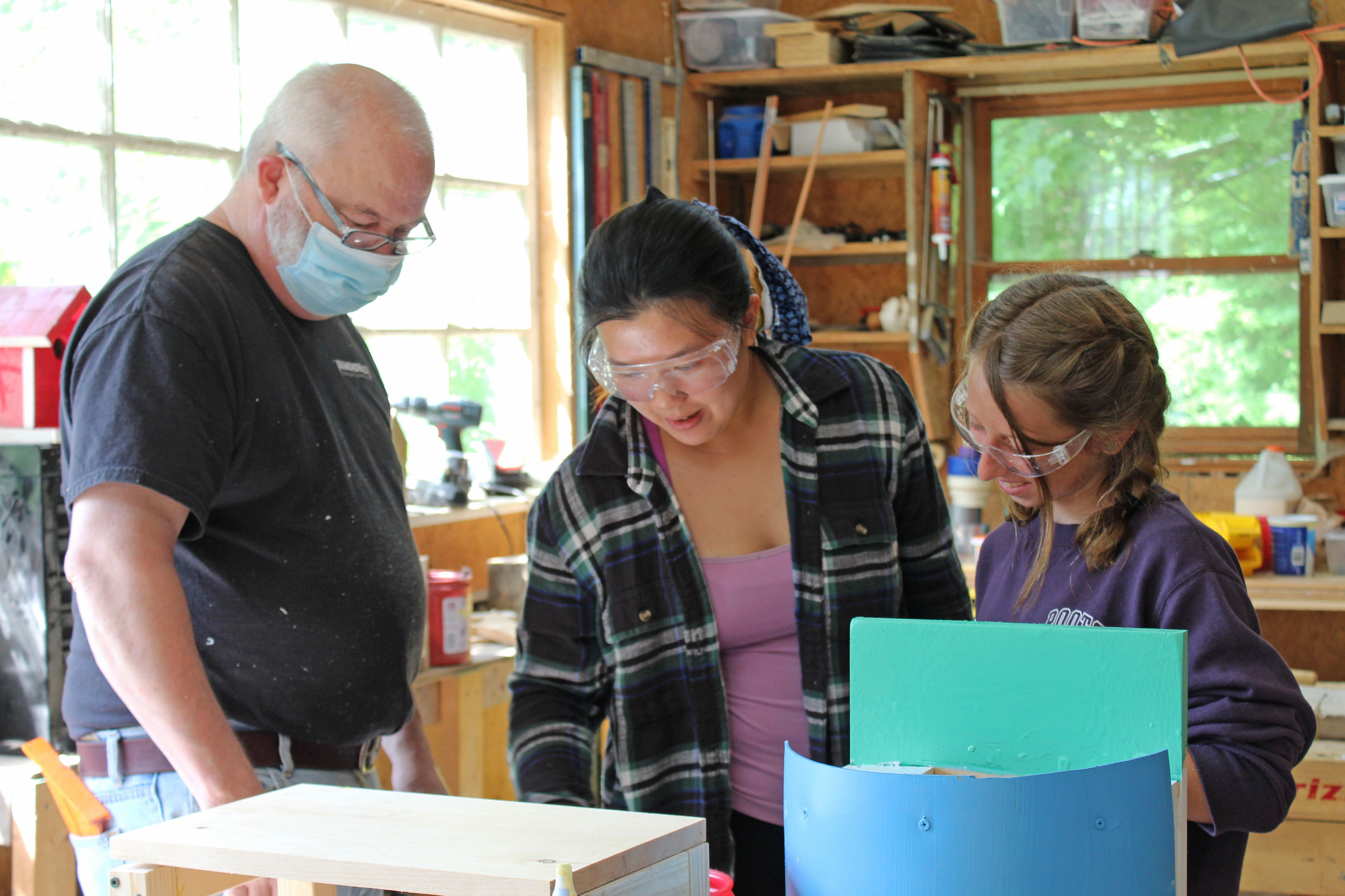 Mark Peters, Anna Zheng and Remi Koebel work on a project in wood working class at Camp Spring Creek in Bakersville. The camp has had to accommodate restrictions and guidelines regarding the ongoing coronavirus pandemic. (MNJ photo/Juliana Walker)