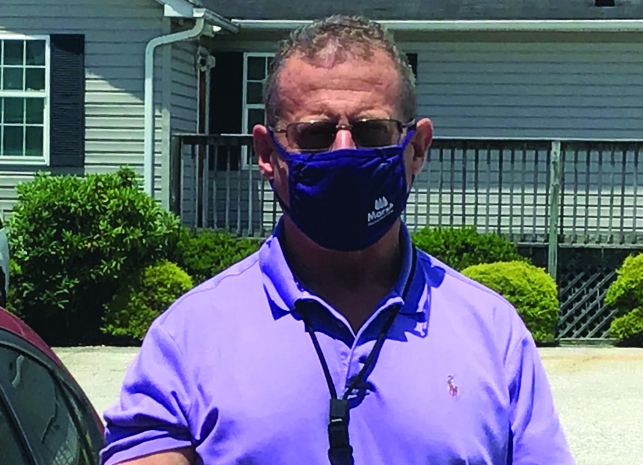 Mitchell County Sheriff Donald Street dons his mask as he prepares to head out on patrol. Street said masks are not a political issue and said he plans to wear one if it helps protect others. He encourages the public to do the same. (Submitted photo)